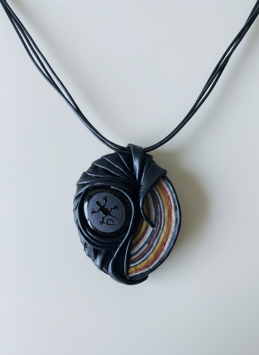 Black pendant with a colorful design on a white background