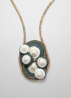 Necklace with a pendant featuring white stones on a gray background